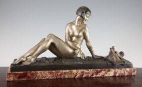 R. Varnier. An Art Deco silvered bronze group of a nude women and two doves, on rouge marble
