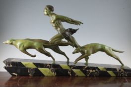 L. Valderi. A 1930s green patinated metal group of a running man with two borzoi, mounted on a