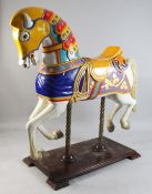 A large carved and polychrome painted fairground carousel horse, in the manner of Charles Looff,