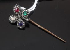 A late Victorian gold and silver, ruby, emerald, sapphire and diamond set clover stick pin, 1.5in.