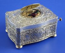 An early 20th century Continental silver singing bird box, of serpentine form, embossed with putti,