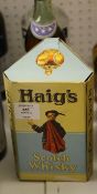 Three bottles of spirit including one Haig`s Dimple Scotch whisky, c. 1950s, hinged cap, with wire