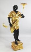 A Venetian gilt painted Blackamoor figure, of a standing male holding a torchere, on a marbled