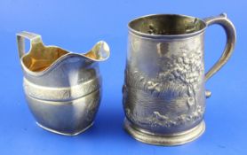 A George II silver mug with later embossed countryside scene and a George III silver helmet shaped