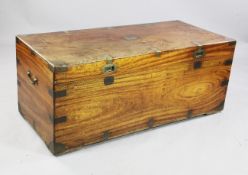 A large 19th century teak trunk, with brass mounts and side handles, W.4ft 2in.
