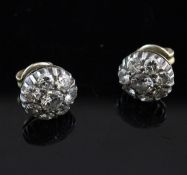 A pair of gold and diamond cluster earrings, of flower head form.