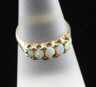 An Edwardian 18ct gold, white opal and diamond half hoop ring, set with five graduated oval opals