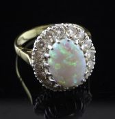 An 18ct gold, white opal and diamond cluster ring, of oval form, size L.