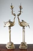 A pair of large Chinese bronze `crane` pricket candlesticks, 19th century, each modelled as a