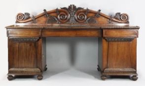 A large 19th century Anglo Indian rosewood pedestal sideboard, the shaped scrolling back rail