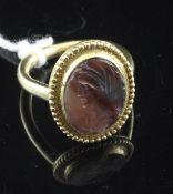 An Antique gold and carnelian intaglio ring, of oval form carved with the head of a gentleman to