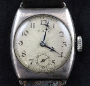 A gentleman`s early 1920`s silver Rolex manual wind wrist watch, with tonneau shaped case and