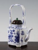 A Chinese blue and white wine pot, Kangxi period, of quatre lobed form, painted with panels of