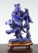 A Chinese lapis lazuli group of a fisherman and his catch, 20th century, in standing pose, on a