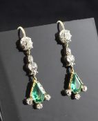A pair of gold, emerald and diamond drop earrings, with two shaped cut emeralds and fourteen old