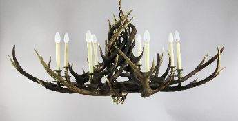 A large stag antler eight branch chandelier, with brass drip pans, W.4ft 5in.