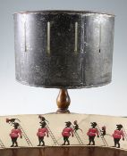 A late Victorian zoetrope, with black painted revolving cylinder, on a turned walnut stand with