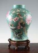 A large Chinese turquoise ground famille rose baluster vase, late 19th century, painted with two