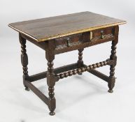 A late 17th century oak side table, the single frieze drawer with brass pear shaped drop handles,