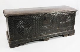 A late 17th century carved oak coffer, the front with stylised geometric roundels, lunettes and