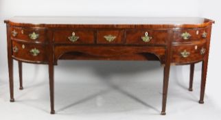 A large early 19th century breakfront mahogany sideboard, with three short frieze drawers above a