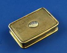 A George III engine turned silver gilt snuff box, of rectangular form, with monogrammed oval silver