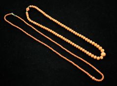 Two single strand graduated coral bead necklaces, with gilt metal or 9ct gold clasps, gross weight