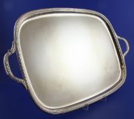 A 1970`s silver two handled tea tray, of rounded rectangular form, with reeded border, on bun feet,