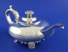A George IV silver teapot, of squat circular form, with banded girdle and embossed finial, on