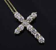 An 18ct gold and diamond cross pendant, set with eleven round brilliant cut diamonds with an