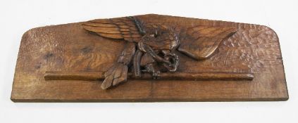 A relief carved oak panel, depicting an eagle and serpent, 51in.