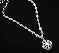 An 18ct white gold and diamond set pendant necklace, the pierced lozenge shaped pendant and chain
