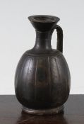 A Greek blackware small Lekythos, Apulian, c.4th century BC, the ovoid body with incised flutes, 3.