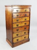 A Victorian walnut Gothic tall chest, of seven graduated drawers with brass handles, on plinth