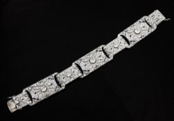 An attractive 1920`s/1930`s white gold, diamond and sapphire encrusted bracelet, with engraved