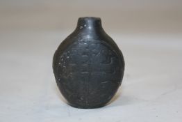 A Chinese Duan stone snuff bottle, probably Imperial, 1740-1800, carved in low relief to one side