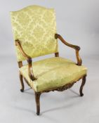 An 18th century French stained beech open armchair, with arched back and serpentine seat