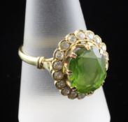 An Egyptian gold, peridot and diamond cluster ring, of oval form, size R.