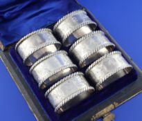 A cased matched set of six late Victorian silver napkin rings, of oval form, numbered 1-6, with