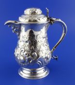 A Victorian silver hot water jug, of baluster tankard form, with mask spout and domed lid with