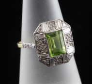 A gold, peridot and diamond ring, of octagonal form, the central peridot bordered by round and
