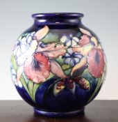 A large Moorcroft Orchid globular vase, c.1950, with a green to blue graduated ground, inscribed WM