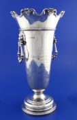A George V silver two handled flower vase, of circular tapering form, with lion mask ring handles
