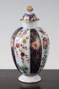 A Worcester polychrome fluted tea canister and cover, in the Queen`s Imari pattern, c.1765-70, the