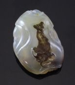 A Chinese Suzhou style agate pendant, carved to a dark brown inclusion in the stone with a fish, on