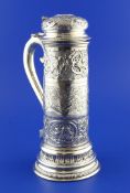 An ornate continental 800 standard silver flagon, of cylindrical tapering form, embossed and