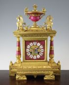 A 19th century French ormolu and porcelain mantel clock, with urn and griffon surmount, the dial