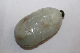 A Chinese celadon and russet jade gourd shaped snuff bottle, 1760-1860, carved in relief with
