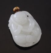 A Chinese white jade `boy` snuff bottle, the seated boy holding a sprig of lotus across his back,