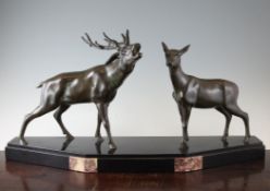 An Art Deco bronze group of a stag and deer, on black marble plinth, 28.5in.